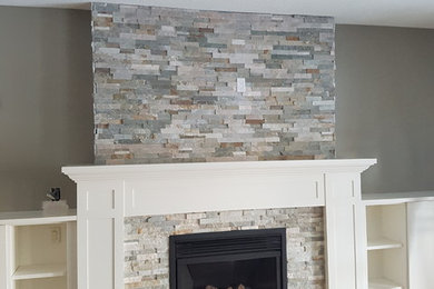 Family room - large transitional open concept light wood floor family room idea in Toronto with brown walls, a standard fireplace, a stone fireplace and no tv