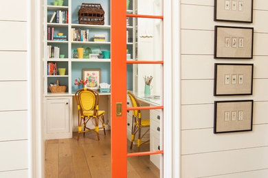 Inspiration for a small country built-in desk light wood floor and brown floor study room remodel in Los Angeles with blue walls