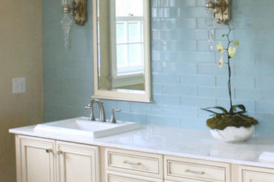 Design ideas for a mid-sized traditional master bathroom in Boston with furniture-like cabinets, white cabinets, a freestanding tub, an alcove shower, a two-piece toilet, blue tile, porcelain tile, blue walls, porcelain floors, a drop-in sink and granite benchtops.