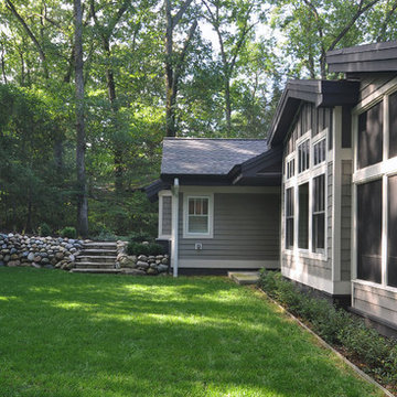 Lodge Look Makeover with Master Bedroom and Garage Addition in Wooded Setting