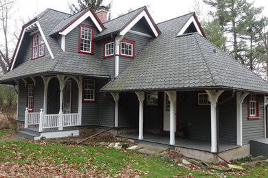 Mid-sized arts and crafts gray two-story wood exterior home photo in Milwaukee with a clipped gable roof