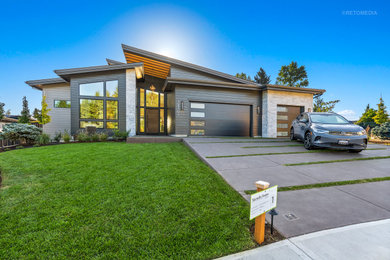 Large minimalist black one-story concrete fiberboard house exterior photo in Portland with a shed roof, a mixed material roof and a black roof