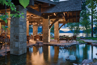 Inspiration for a rustic backyard stone patio remodel in Other