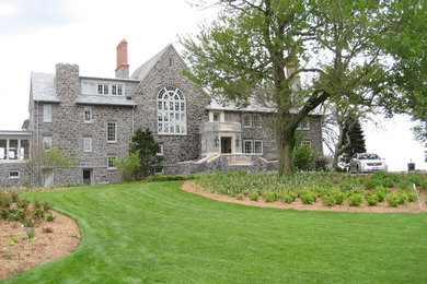 This is an example of a mid-sized traditional full sun front yard landscaping in New York.