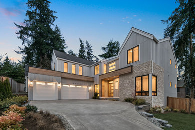 Inspiration for a huge country white three-story board and batten house exterior remodel in Seattle with a black roof