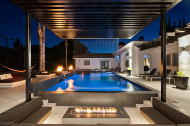 Inspiration for a large modern backyard rectangular pool remodel in Orange County