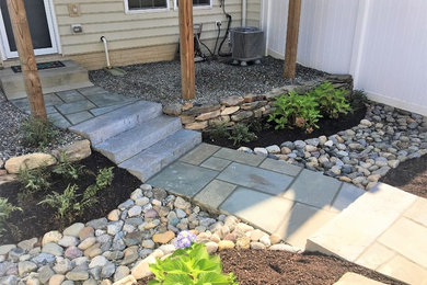 Inspiration for a backyard garden in DC Metro with natural stone pavers.