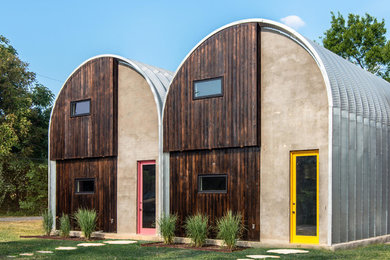 Small industrial two-story metal house exterior idea in Nashville with a metal roof