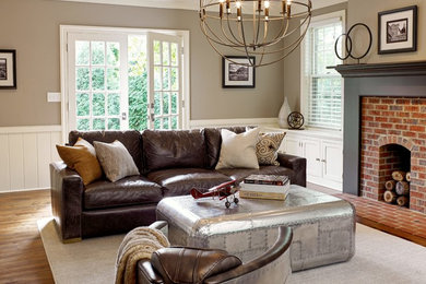 Mid-sized trendy enclosed dark wood floor family room photo in Milwaukee with a standard fireplace, a brick fireplace, beige walls and a tv stand