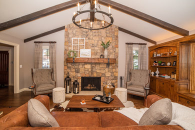Living room - mid-sized transitional dark wood floor and brown floor living room idea in Detroit with a standard fireplace, a stone fireplace and gray walls