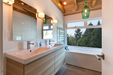 Alcove bathtub - mid-sized contemporary master ceramic tile and gray floor alcove bathtub idea in Vancouver with flat-panel cabinets, light wood cabinets, white walls, an integrated sink and solid surface countertops