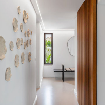 Hallway with green-backed shelving and wall objects, Alfragide