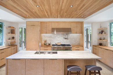 Example of a huge minimalist u-shaped concrete floor, gray floor and wood ceiling kitchen design in Portland with an undermount sink, flat-panel cabinets, light wood cabinets, quartzite countertops, gray backsplash, stone slab backsplash, paneled appliances, an island and gray countertops
