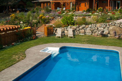 Example of a large backyard custom-shaped pool design in Vancouver