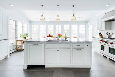 Transitional eat-in kitchen in New York with an undermount sink, beaded inset cabinets, white cabinets, granite benchtops, white splashback, subway tile splashback, stainless steel appliances, porcelain floors and with island.