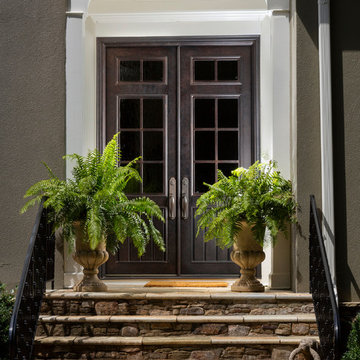 Illuminating Entryway Featuring Custom Double Iron Doors