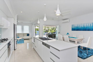 This is an example of a beach style kitchen in Cairns.