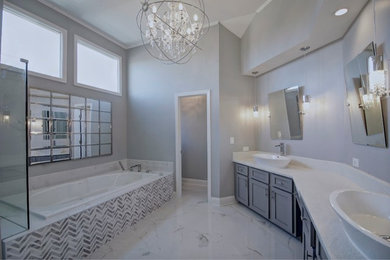 Inspiration for a large transitional master bathroom in Atlanta with shaker cabinets, grey cabinets, a drop-in tub, a corner shower, gray tile, white tile, ceramic tile, grey walls, marble floors, a vessel sink and granite benchtops.