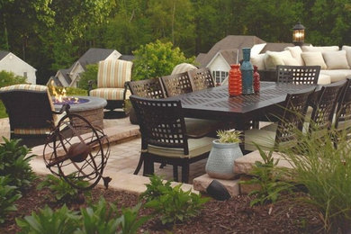 Patio - large traditional backyard brick patio idea in Richmond with a fire pit and no cover