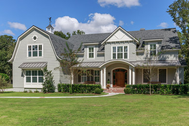 Farmhouse two-story concrete fiberboard house exterior idea in Jacksonville with a gambrel roof and a mixed material roof