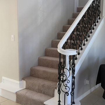White Staircase with Iron Balusters