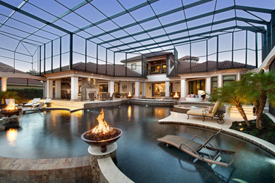 Inspiration for a large mediterranean indoor concrete and custom-shaped infinity pool fountain remodel in Miami