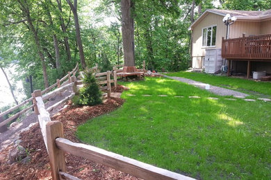 Inspiration for a large traditional backyard stone water fountain landscape in Minneapolis.
