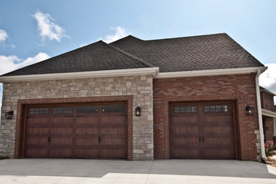 Two-story brick exterior home photo in Other with a hip roof