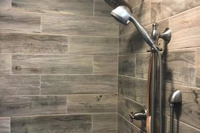 Example of a mid-sized transitional beige tile and porcelain tile corner shower design in Indianapolis