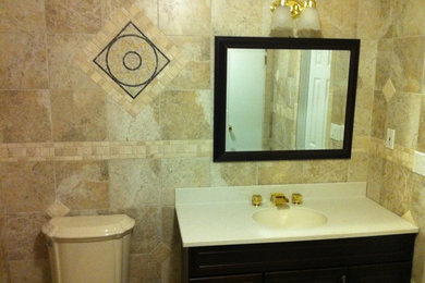 Photo of a mid-sized traditional bathroom in New York with a two-piece toilet and multi-coloured tile.