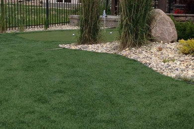 Full synthetic turf backyard with putting green.