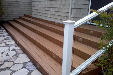 Photo of a mid-sized traditional partial sun backyard retaining wall landscape in San Francisco with decking.