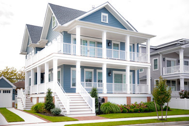 Large transitional blue three-story wood house exterior idea in Other with a gray roof
