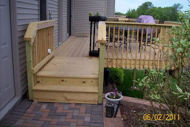 Mid-sized elegant backyard deck photo in Milwaukee with no cover