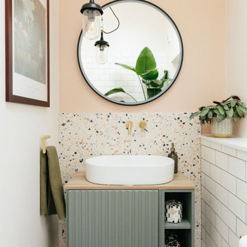 Pink & green bathroom with mix of tiles & patterns