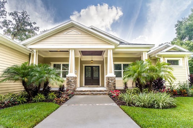 Inspiration for a mid-sized arts and crafts one-storey beige exterior in Tampa with vinyl siding and a hip roof.
