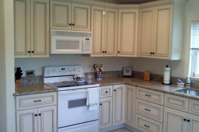 Mid-sized traditional l-shaped separate kitchen in Miami with an undermount sink, beaded inset cabinets, beige cabinets, granite benchtops, white appliances, ceramic floors and beige floor.