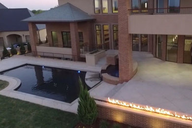 Minimalist backyard tile and custom-shaped pool photo in Oklahoma City