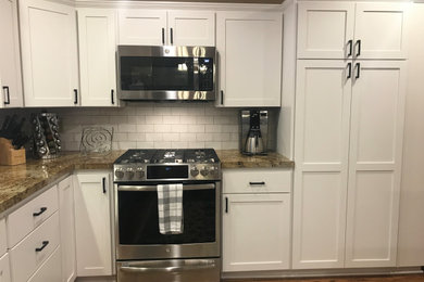 Kitchen photo in Phoenix with shaker cabinets, white cabinets, white backsplash and ceramic backsplash