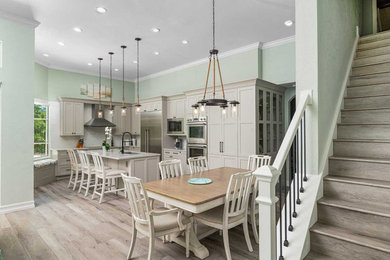 Example of a large transitional l-shaped light wood floor and beige floor eat-in kitchen design in Miami with an undermount sink, shaker cabinets, beige cabinets, quartz countertops, multicolored backsplash, mosaic tile backsplash, stainless steel appliances, an island and multicolored countertops