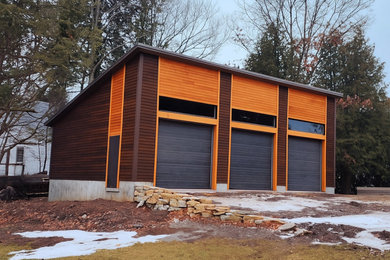 Inspiration for a large eclectic detached three-car garage remodel in Other