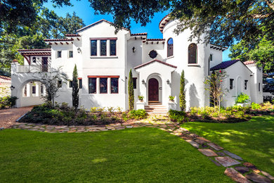 Photo of a mediterranean two-storey white exterior in Tampa.