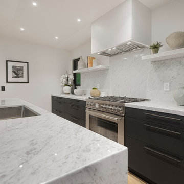 After - Slab Backsplash and Floating Shelves Beside the Range