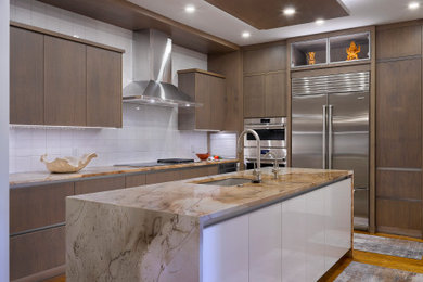 Inspiration for a mid-sized contemporary medium tone wood floor and brown floor open concept kitchen remodel in Cleveland with an undermount sink, flat-panel cabinets, brown cabinets, granite countertops, white backsplash, porcelain backsplash, stainless steel appliances, an island and beige countertops