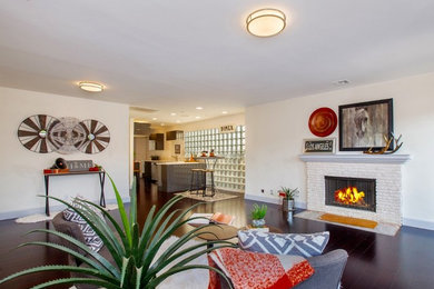 Living room - mid-sized eclectic formal and open concept dark wood floor living room idea in Los Angeles with white walls, a standard fireplace, a brick fireplace and no tv