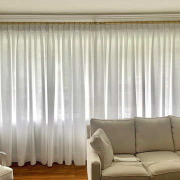 Wall of Linen Pinch Pleat Drapes on Gold TRAX Rod