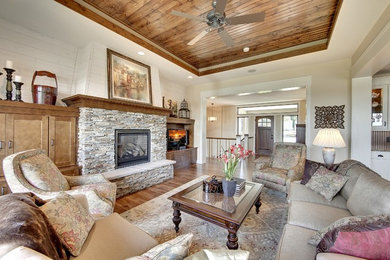 Traditional living room in Minneapolis with a standard fireplace and a stone fireplace surround.