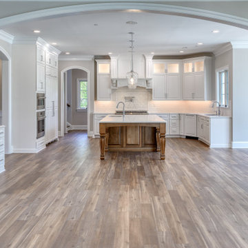 Transitional Kitchen with Two Toned Gathering Island & Archways