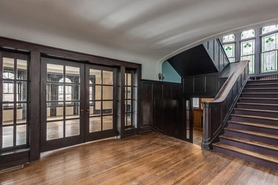 Inspiration for a large timeless wooden u-shaped wood railing staircase remodel in Detroit with wooden risers