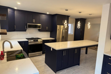 Eclectic kitchen photo in Toronto with an island